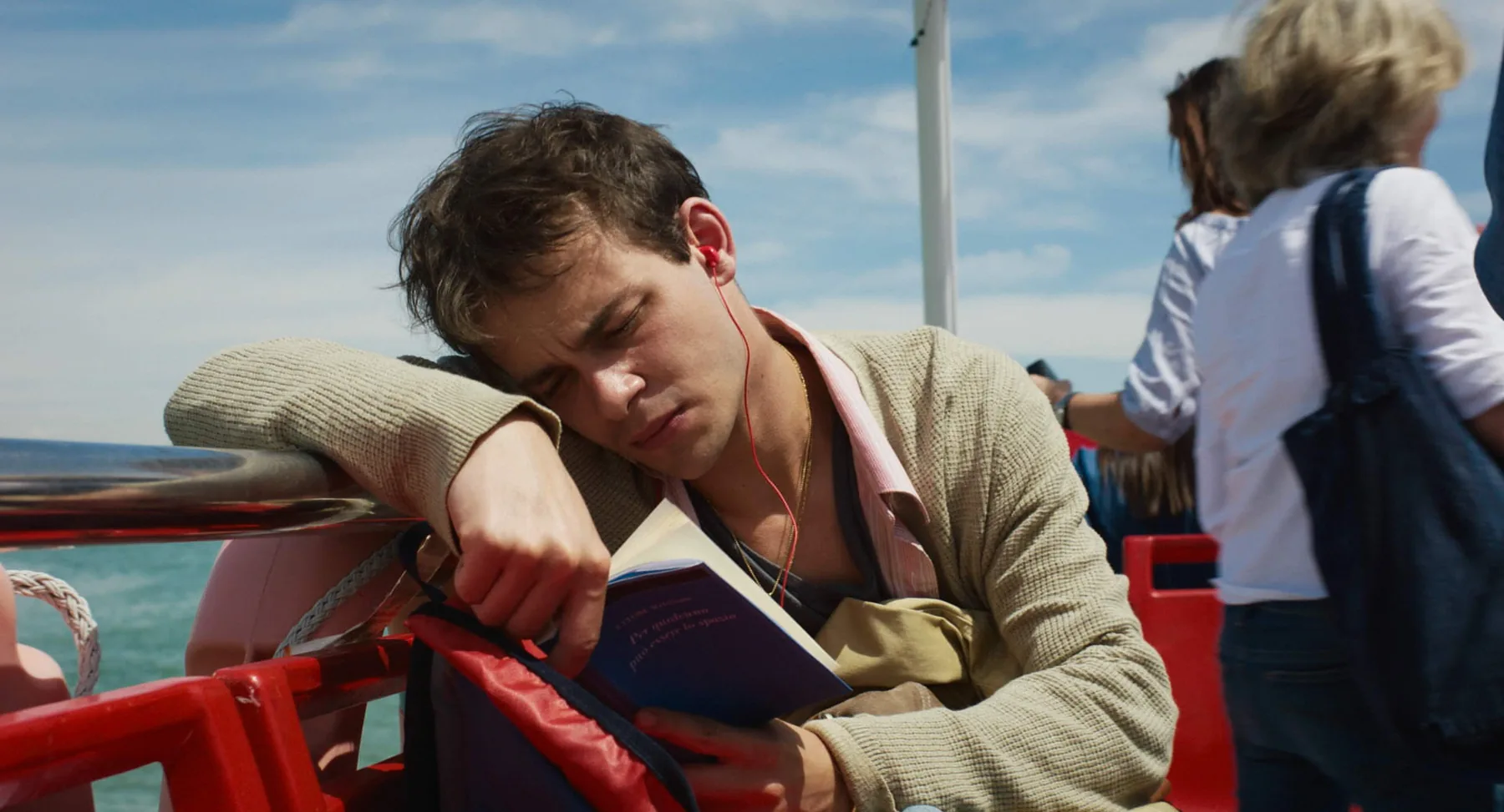 Marco rests on a boat beside the lagoon as he returns home.