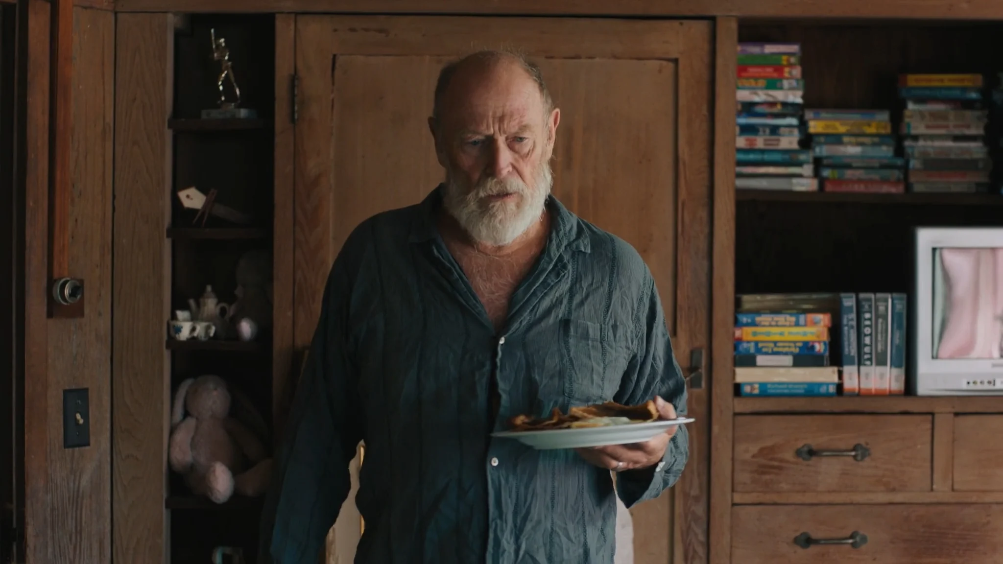 Lenny stands alone in his home in a scene from the WOODSTOCKERS pilot.